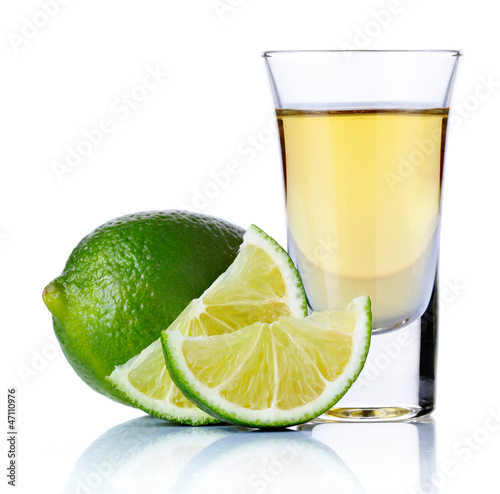 Photo: Gold tequila shot with lime isolated on white Gold tequila shot with lime isolated on white