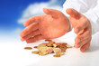 Hands and coins over white.