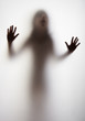a girl silhouette behind a  transparent  paper background