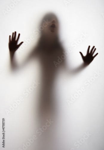  a girl silhouette behind a transparent paper background