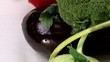 Vegetables arranged on a white table, tilt up