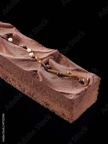 Photo: Chocolate cake on black background Chocolate cake on black background