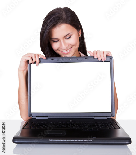 Photo: Smiling woman with blank laptop screen Smiling woman with blank laptop screen