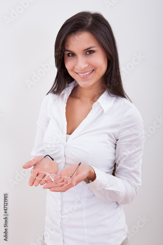 Photo: Woman holding a pair of spectacles Woman holding a pair of spectacles