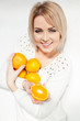 beautiful young and healthy women with yellow tangerines