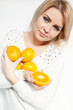 beautiful young and healthy women with yellow tangerines