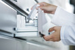 Photo: Pharmacist reaching for medicine Pharmacist reaching for medicine