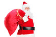 A Santa Claus walking with bag full of gifts og his back