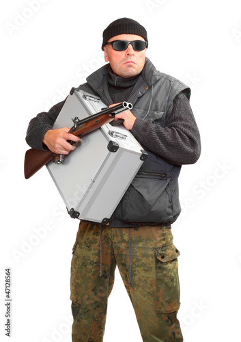 Photo: Dangerous gangster with gun and stolen money in suitcase. Dangerous gangster with gun and stolen money in suitcase.