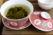 A chinese gaiwan with tea on a tea table