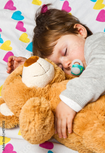 Photo: Sweet child sleeping with teddy bear Sweet child sleeping with teddy bear