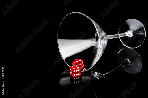 Photo: two red dice in a cocktail glass two red dice in a cocktail glass