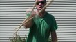 Man Swinging Stick at Camera