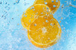 water splashing on orangei slices-top view