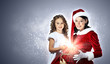 Little girl with christmas gifts and santa