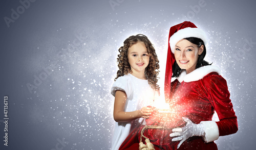 Photo: Little girl with christmas gifts and santa Little girl with christmas gifts and santa