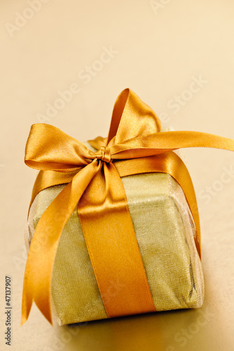 Photo: Golden wrapped gift box Golden wrapped gift box