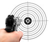 hand with gun shooting target