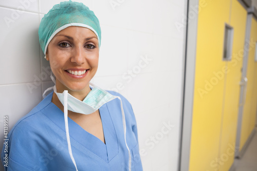 Photo: Smiling nurse leans against wall Smiling nurse leans against wall