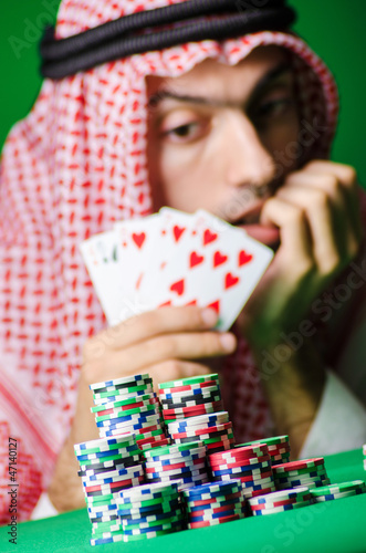 Photo: Arab playing in casino - gambling concept with man Arab playing in casino - gambling concept with man