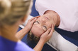 Photo: Young therapist doing reiki therapy to senior woman Young therapist doing reiki therapy to senior woman