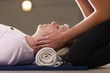 Photo: Young therapist arranging crystals on female client for reiki th Young therapist arranging crystals on female client for reiki th