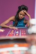Woman looking upset at roulette table