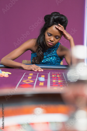 Photo: Woman looking upset at roulette table Woman looking upset at roulette table
