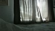Man Opening Curtains in Bedroom