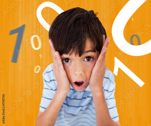 Photo: Boy looking scared against orange background Boy looking scared against orange background