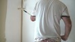 Man Rolling Paint onto Wall