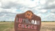 Lutheran Church Sign - Rusty Metal - Bullet Holes