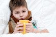 Sick boy lying in bed