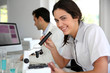 Photo: Portrait of smiling student in microbiology Portrait of smiling student in microbiology