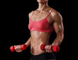 Fitness woman with barbells on black background