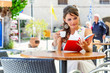 Young woman is sitting in the cafe