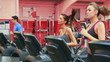 Three persons running on a treadmill