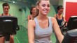 Happy woman on exercise bike