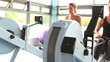 Two women drawing on row machine