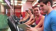 Trainer talking to woman on exercise bike