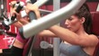 Women training on weights machine