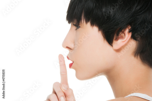 Photo: Beautiful girl withe finger on her lips Beautiful girl withe finger on her lips