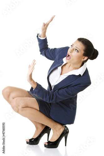 Photo: Scared businesswoman defending herself Scared businesswoman defending herself