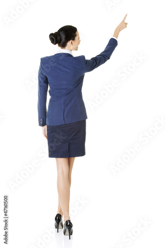 Photo: Business woman pointing on copy space Business woman pointing on copy space