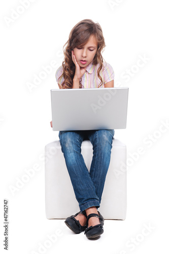 Photo: girl is boring and looking at the laptop girl is boring and looking at the laptop