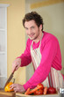 Young man chopping a bell pepper