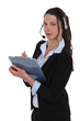 Brunette call-center worker writing on clip-board