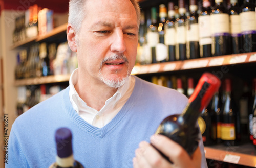 Photo: Man comparing two wines Man comparing two wines