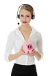 Photo: Business woman with headset holding piggy bank Business woman with headset holding piggy bank