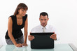 businessman in front of his laptop looking surprised